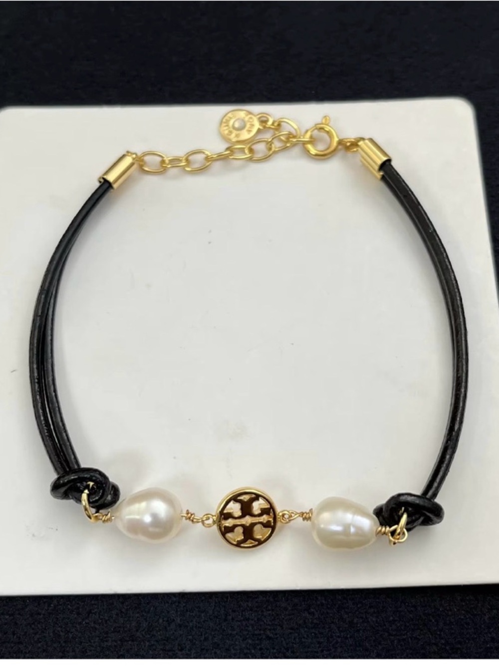 Tory Burch Black Cord Bracelet with Gold Logo & White Pearls & Faux Leather